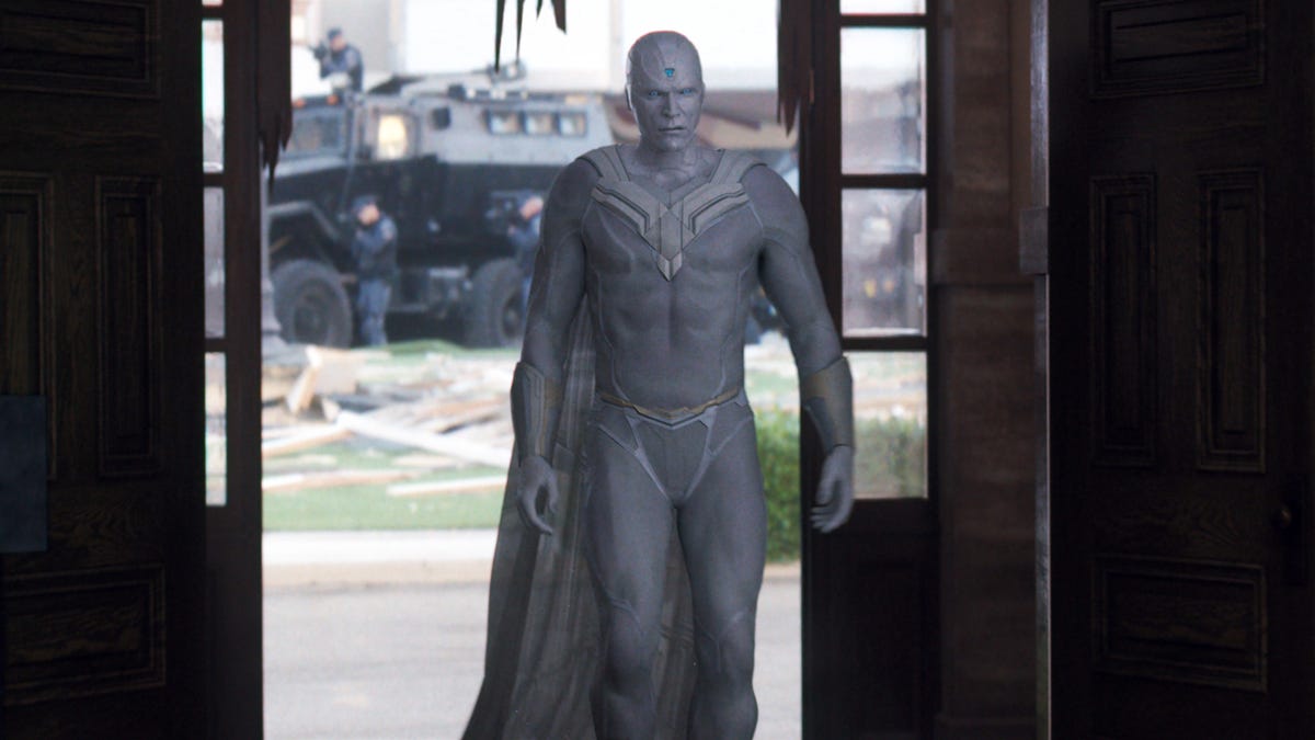 The all-white, zero-personality Vision strides hauntingly into the remains of a building in Wanda's town.