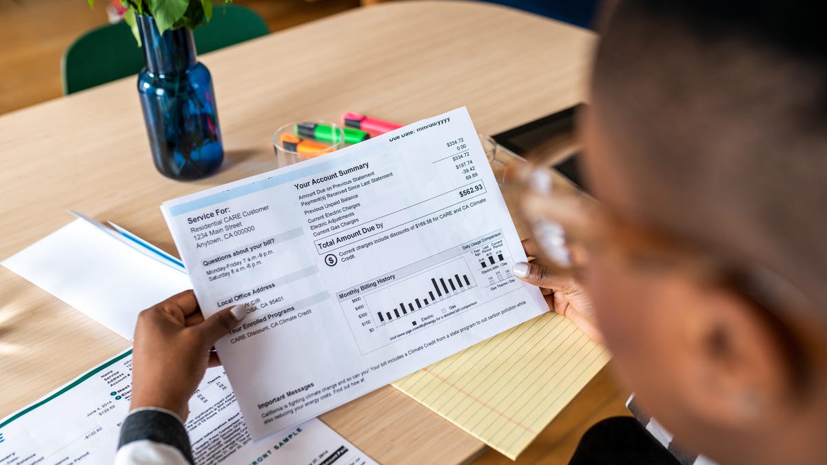 A young woman looks at the electricity bill.