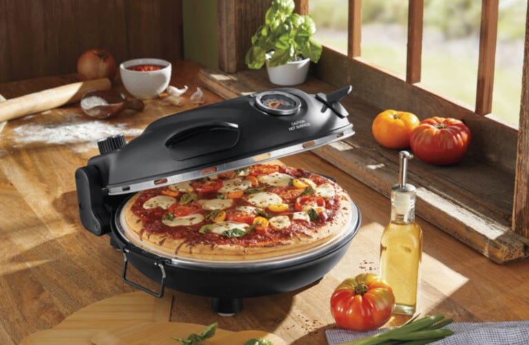 pizza oven on counter with pizza inside