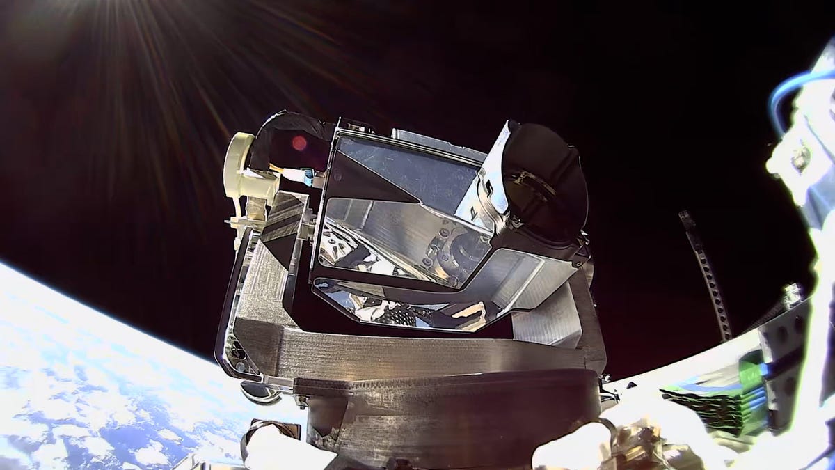 A metal module containing a laser operating on a satellite in low-Earth orbit.