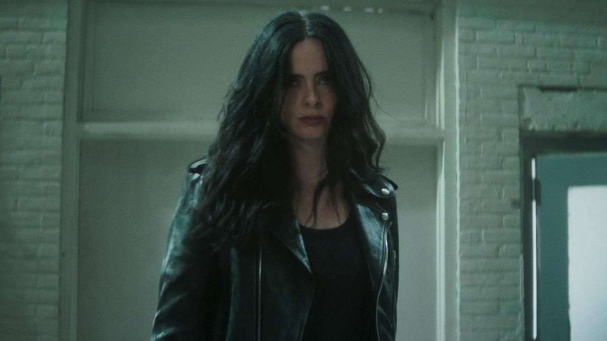 krysten ritter as jessica jones stares intensely at something in daredevil born again, season 2