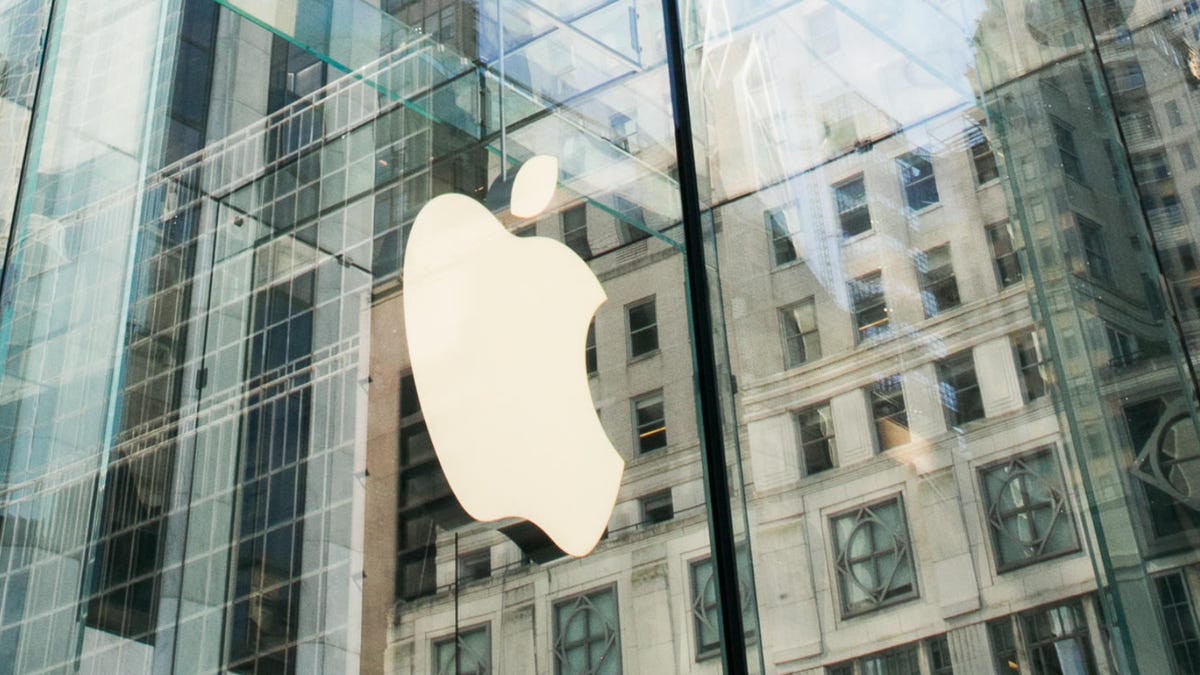 Apple logo in cream on the outside glass of the Apple Store on Fifth Avenue in Manhattan