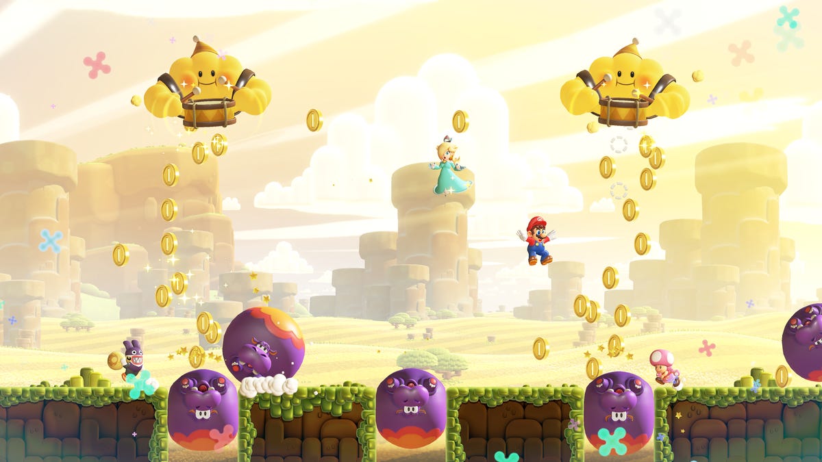 Super Mario Bros. Wonder game screenshot showing Mario, Rosalina and Nabbit collecting lots of coins.