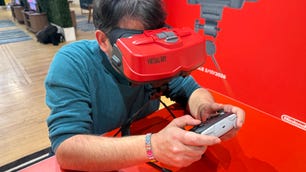 Scott Stein leaning into the Virtual Boy to play a game