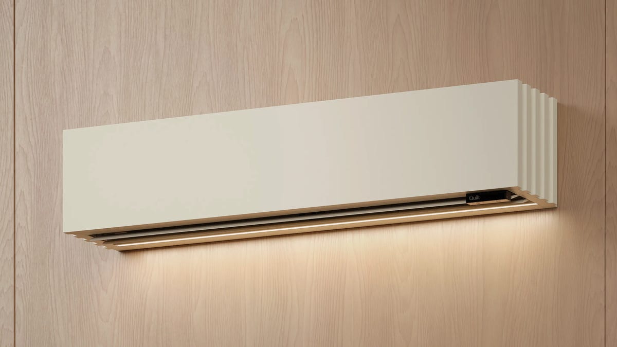 A woman and boy in a well-lit kitchen with a heat pump unit on the wall.