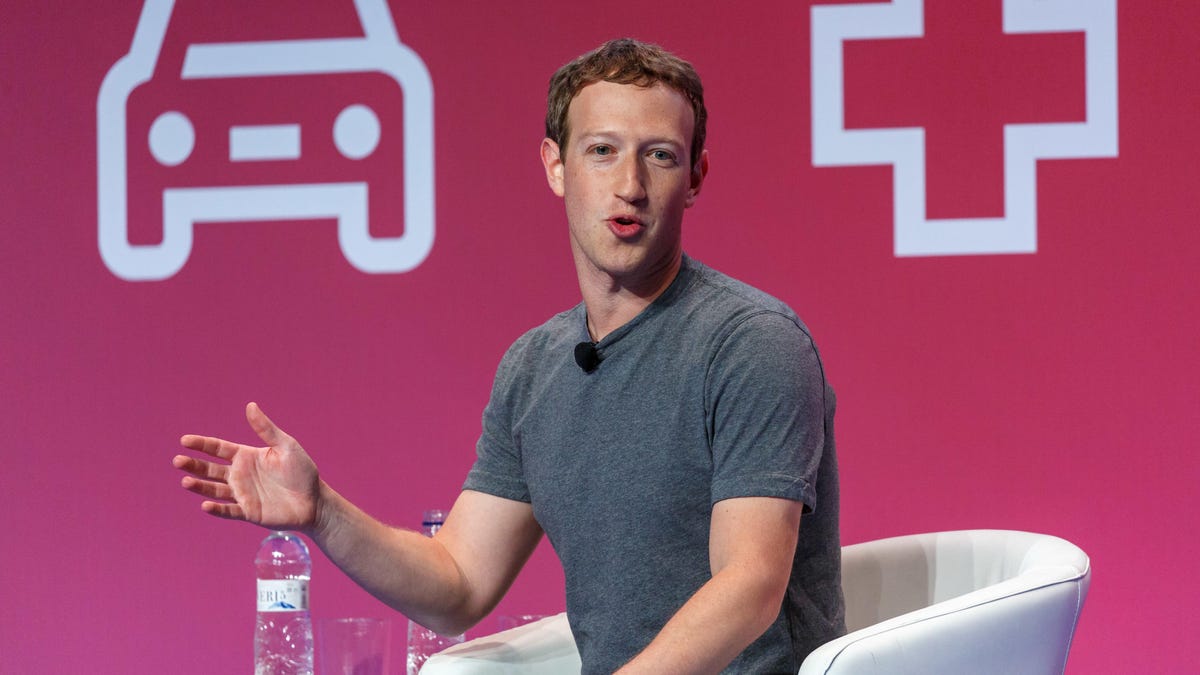 Meta CEO Mark Zuckerberg speaking at a conference while wearing his trademark gray T-shirt
