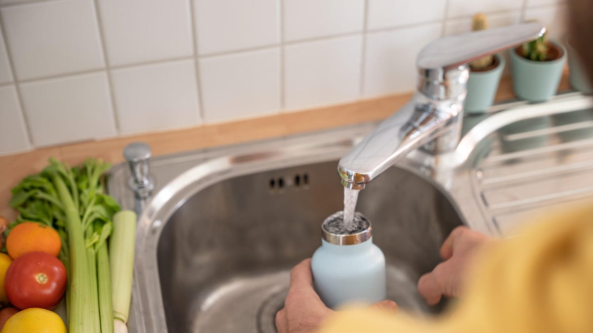 Washing a bottle in the sink