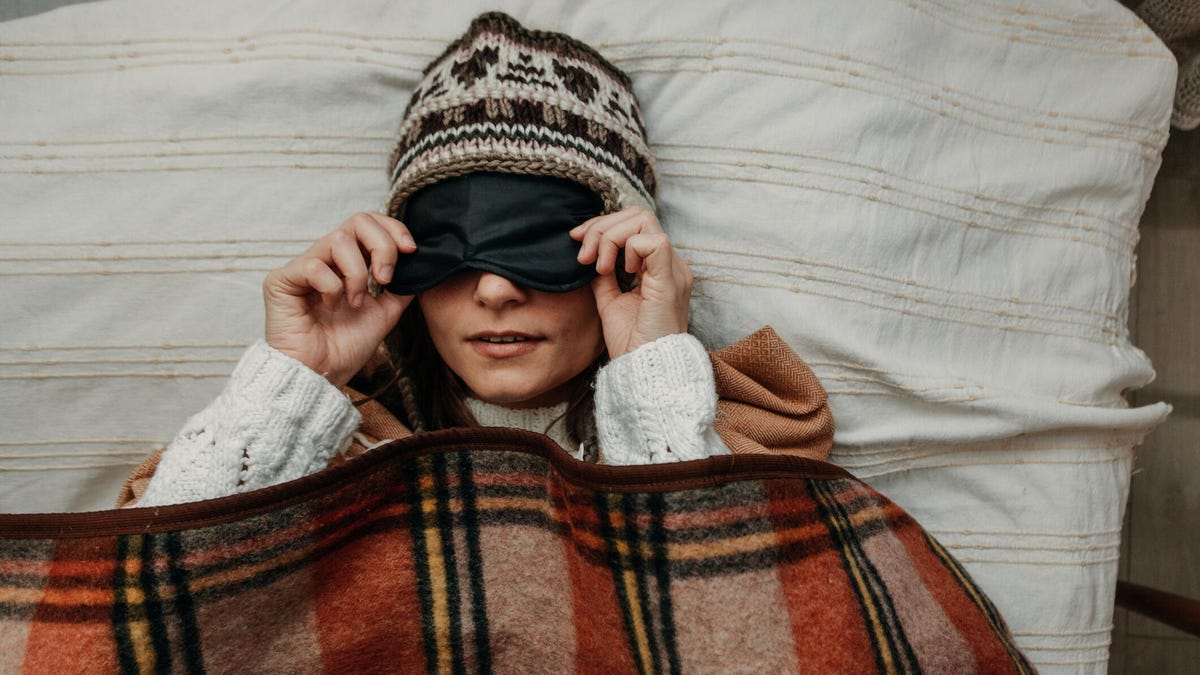Woman bundled up in bed during the winter