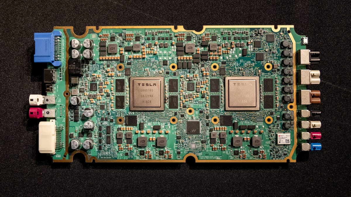 Two big, square AI processors power Tesla's third-generation full self-driving car computer. Tesla showed the computer at the Hot Chips conference.