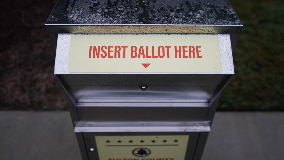 Absentee ballot drop box with a sign that says, "Insert ballot here."