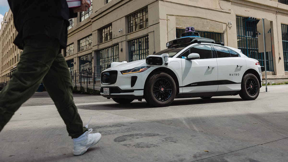 A Waymo-operated Jaguar I-Pace drives the streets of Los Angeles