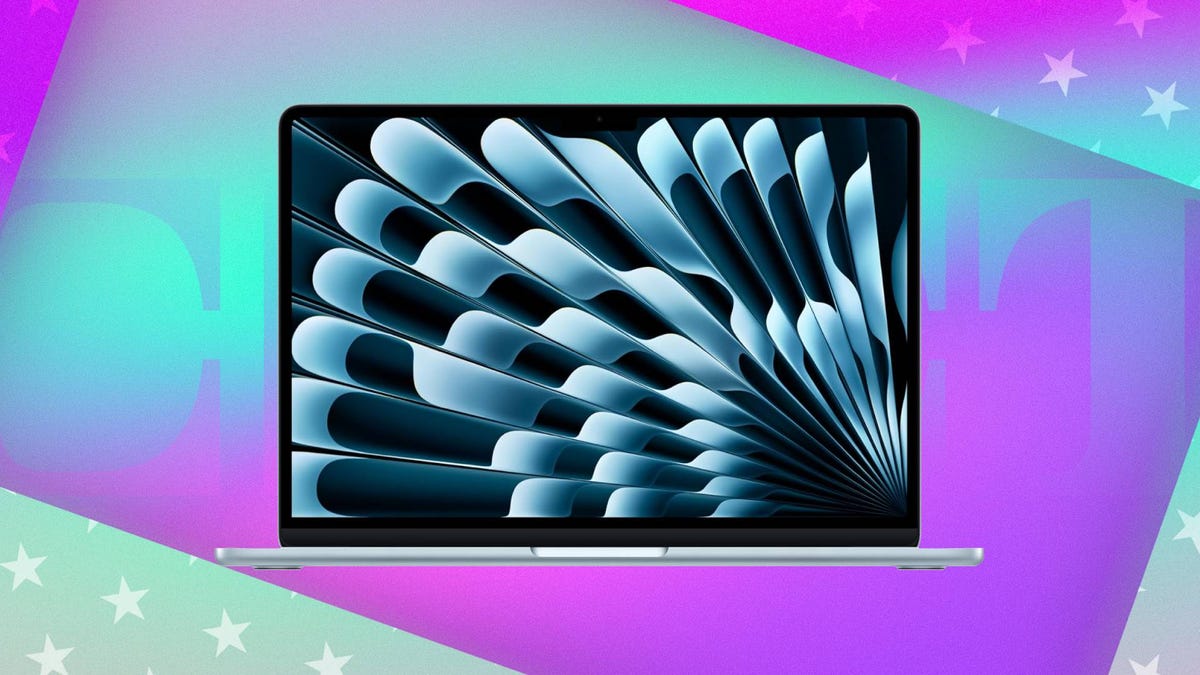 An open Apple laptop against purple and green CNET background.