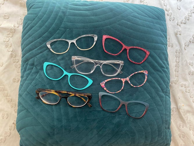 Pair Eyewear glasses on a pillow