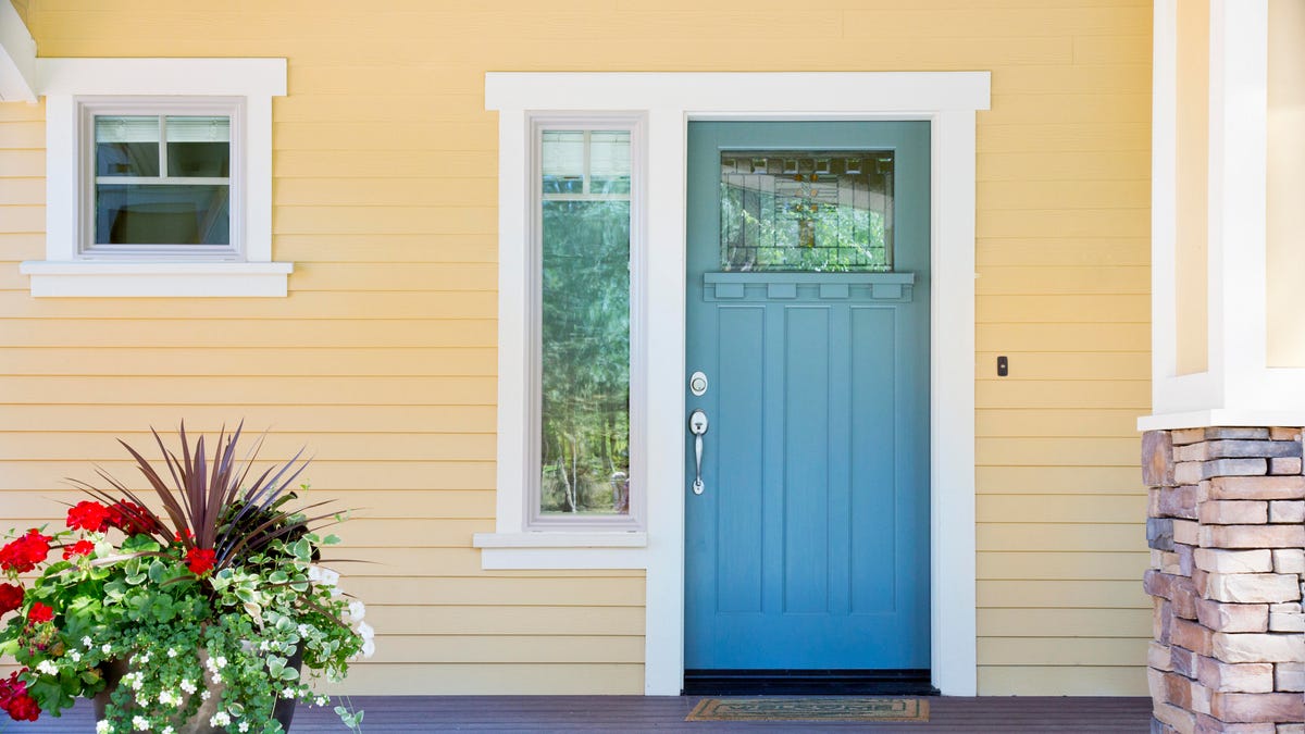 A yellow house with a blue front door