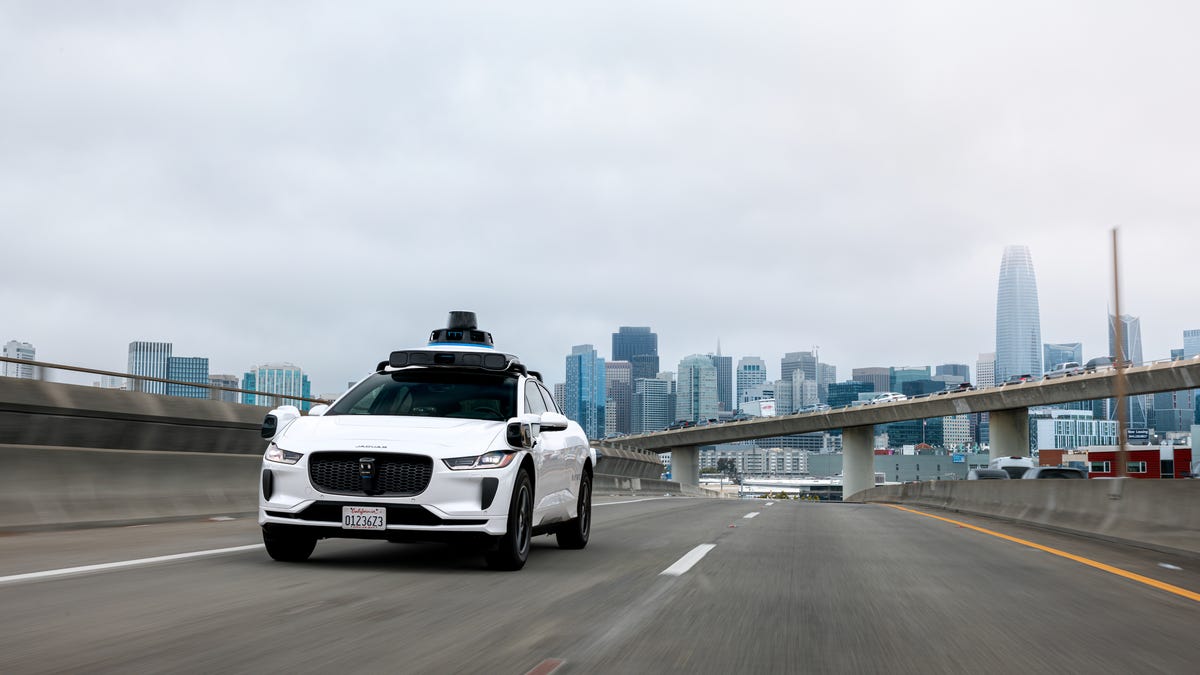 A Waymo robotaxi drives on a freeway in the San Francisco Bay Area