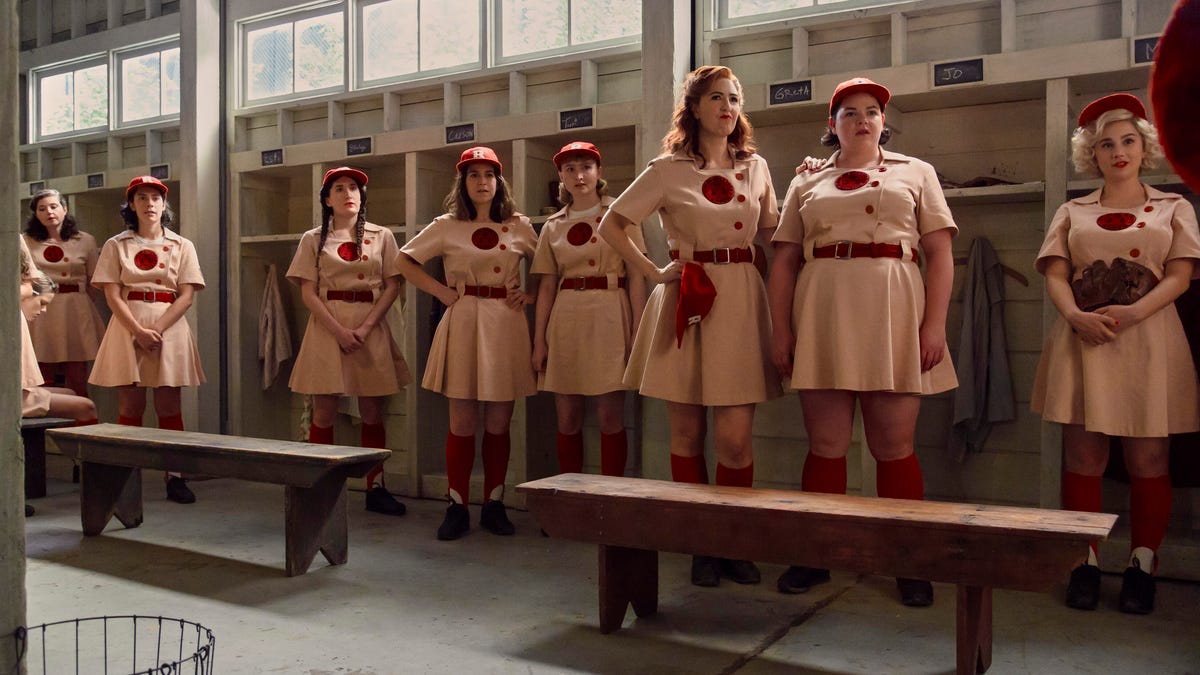 The Rockford Peaches stand in a line in their locker room.
