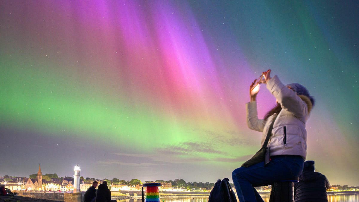 Image of someone taking a photo of the northern lights