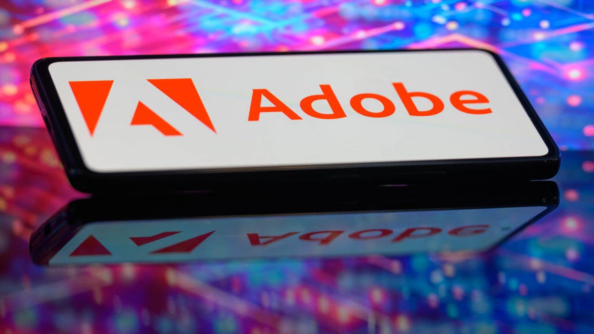 Adobe logo is shown on a smartphone.