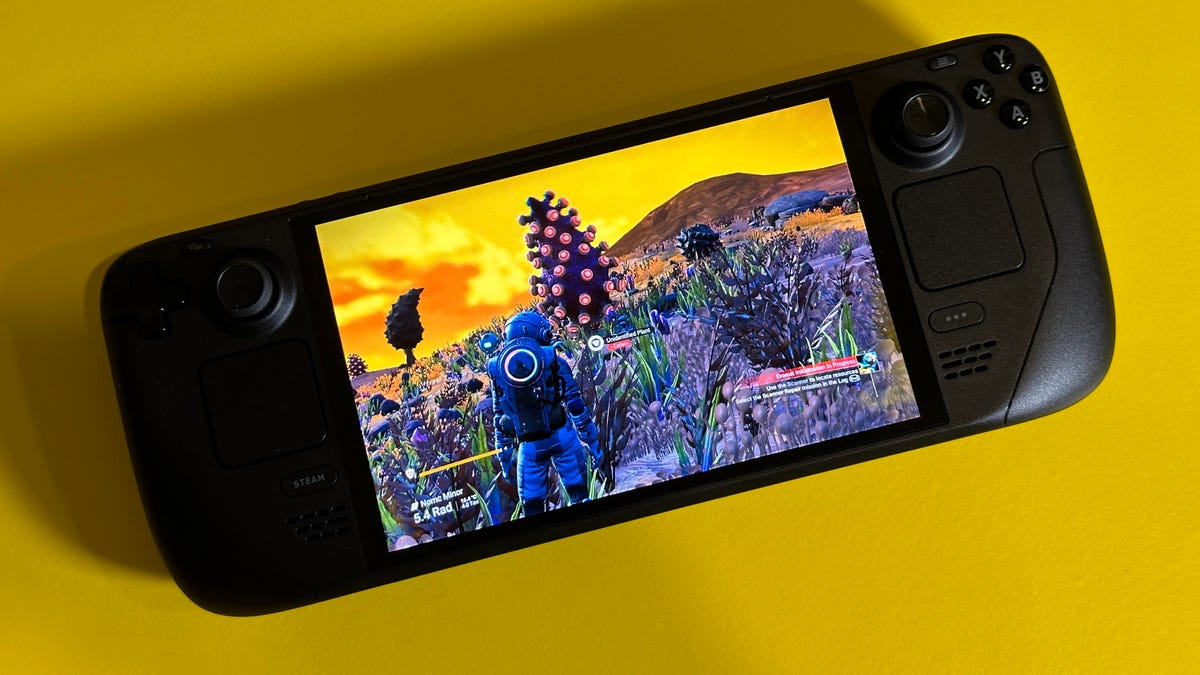 Steam Deck game handheld with No Man's Sky on screen, and yellow background