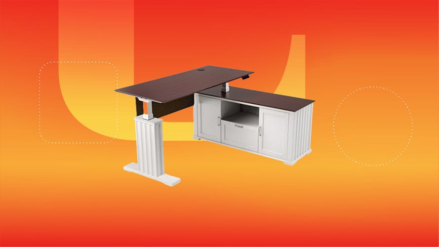 A white L-shaped desk on an orange and red background