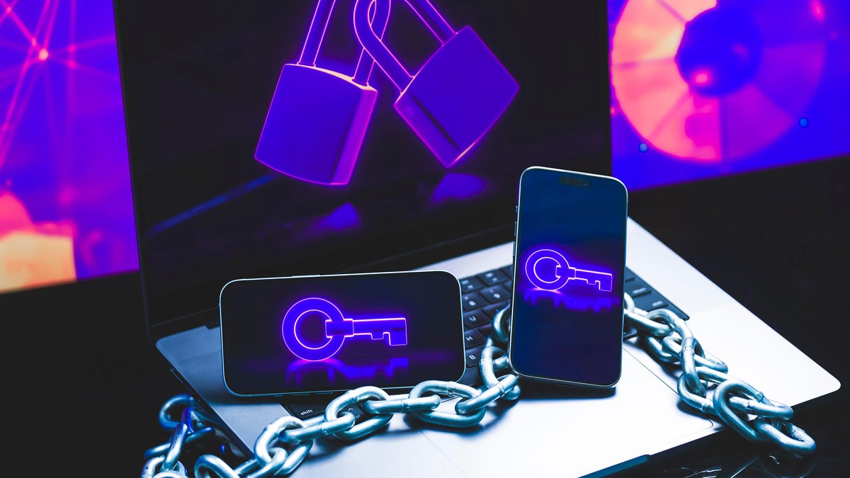 Keys and locks and chains on mobile phones and a laptop