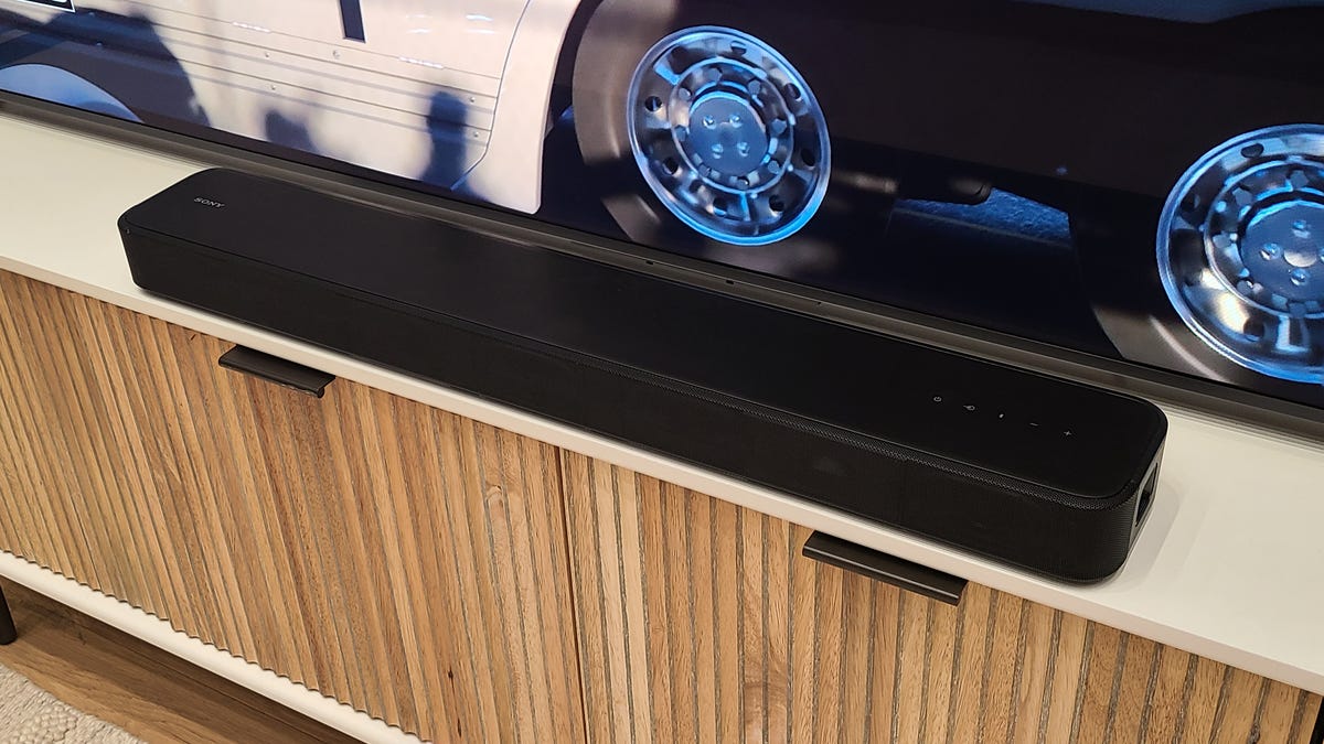 Sony HT-S2000 Soundbar on a cabinet beneath a TV screen