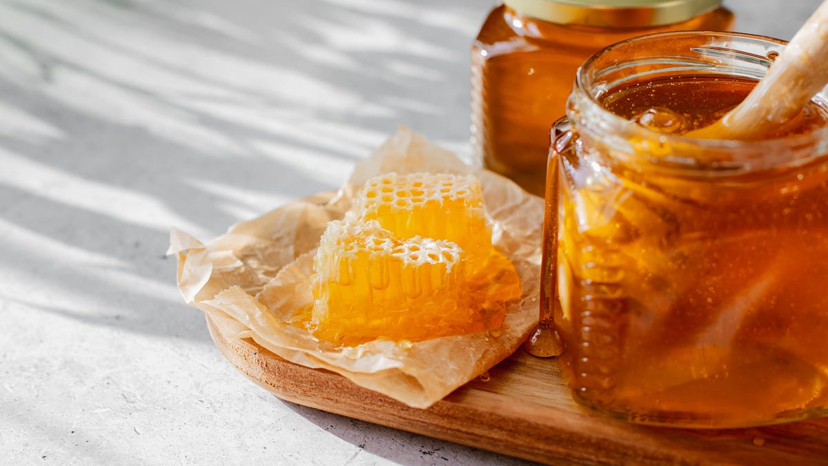 Honey and honeycomb on a white background