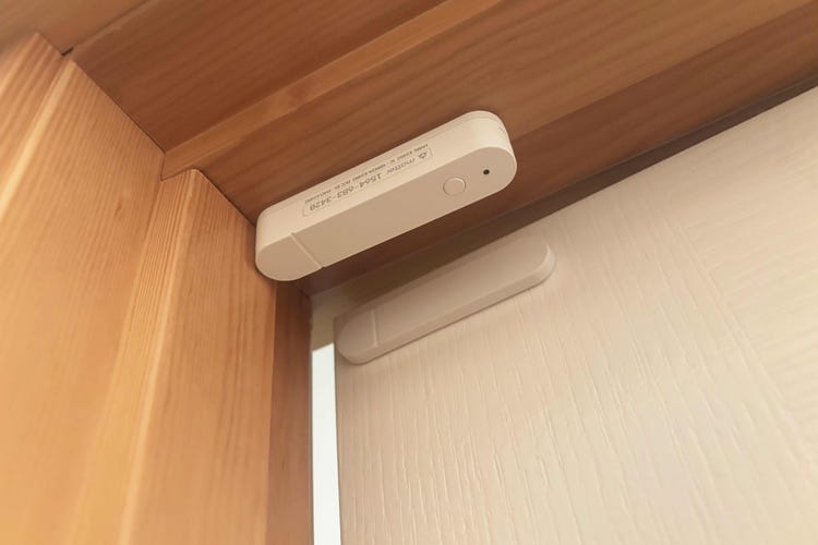 Ikea's access sensor on a wood door frame.