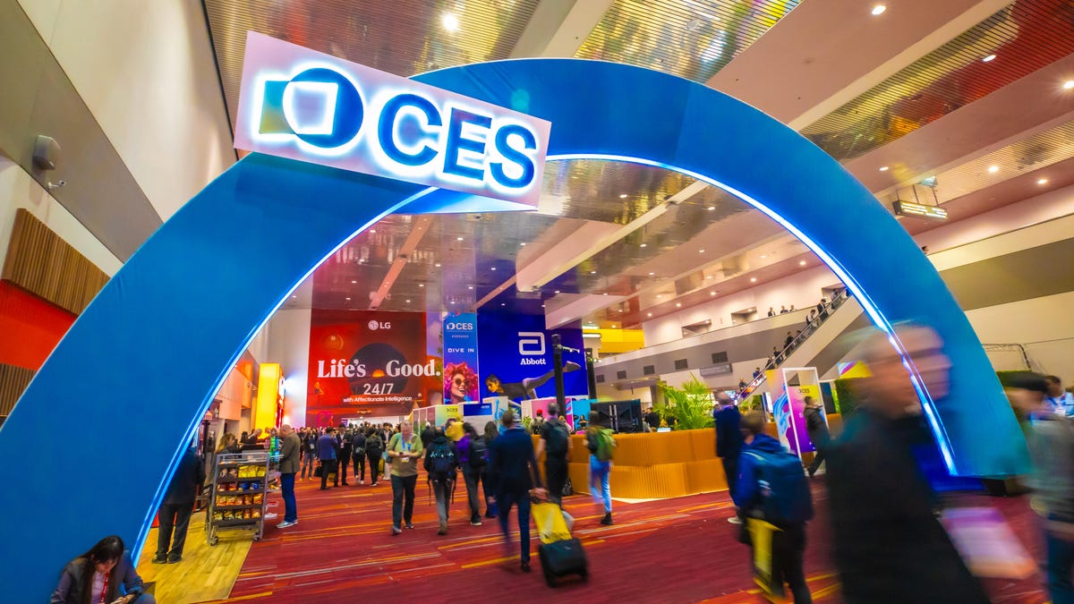 Attendees walk under a CES sign during CES 2024 at the Las Vegas Convention Center.