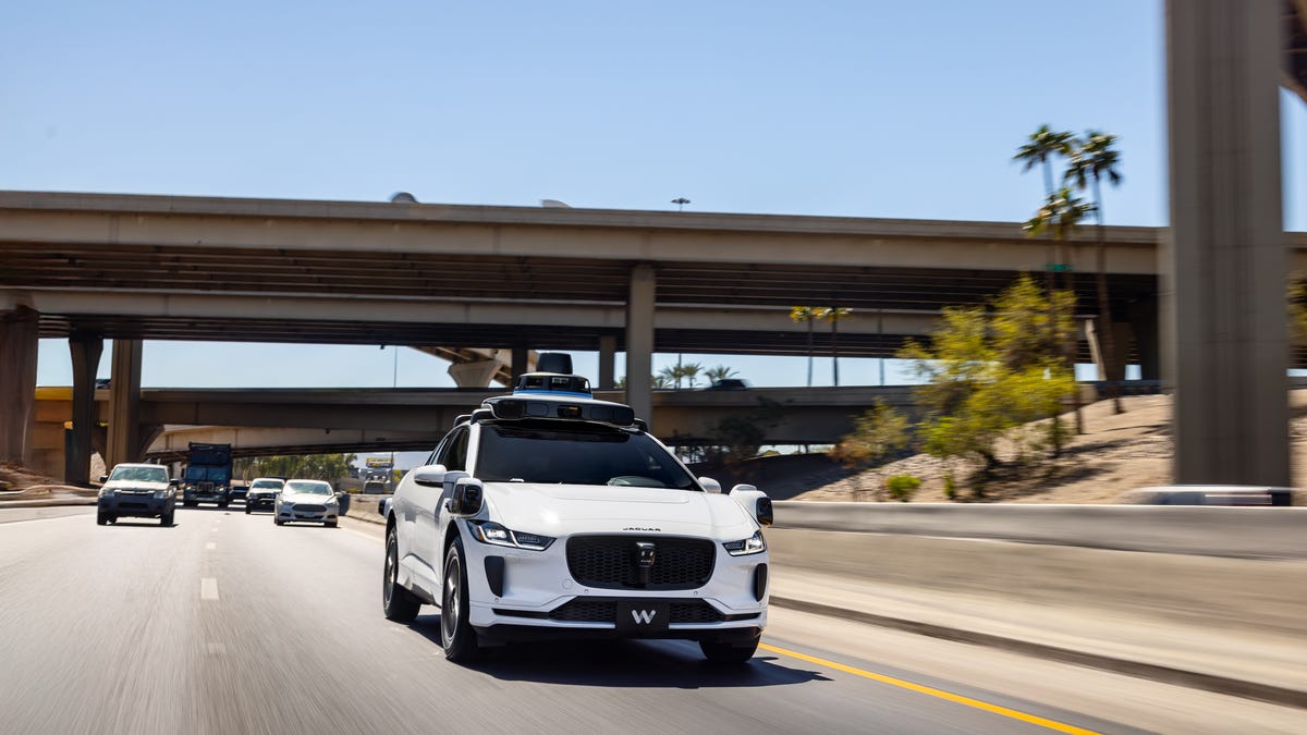 A Waymo-operated Jaguar I-Pace drives on the freeway in Phoenix