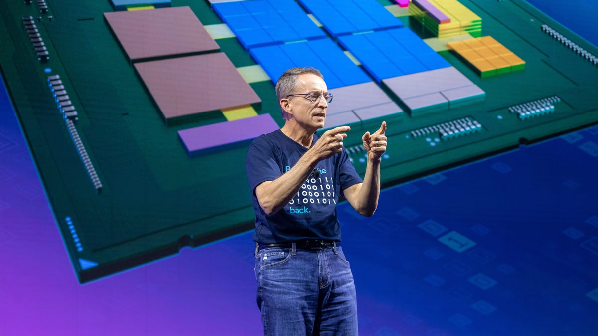 Intel CEO Pat Gelsinger gestures on stage while wearing a T-shirt that reads "bringing the geek back."