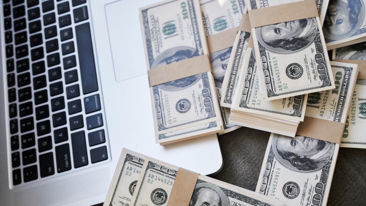 Cash money and laptop computer