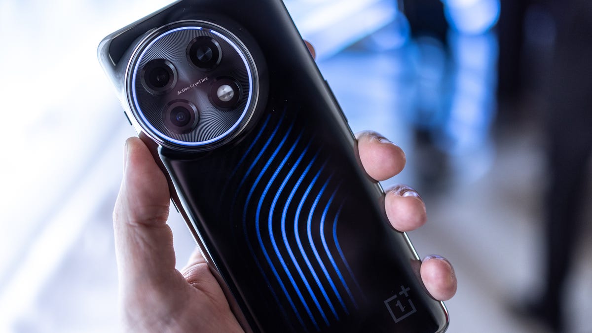 A phone being held with blue lights on the back