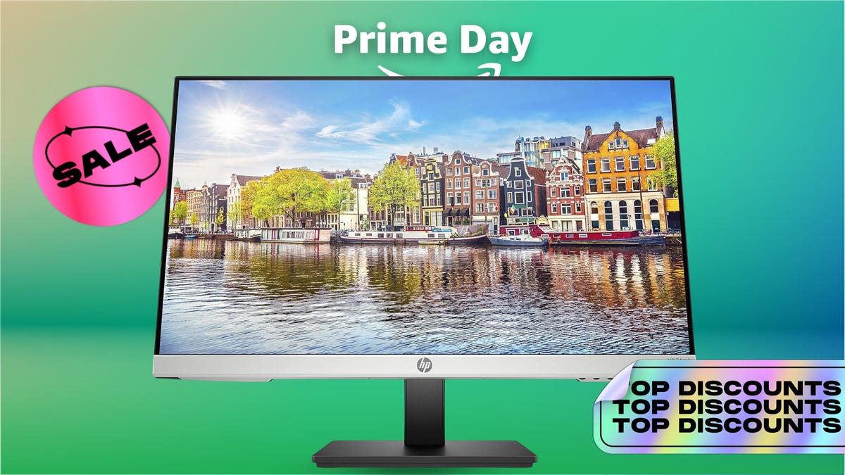 A silver monitor against a green background.