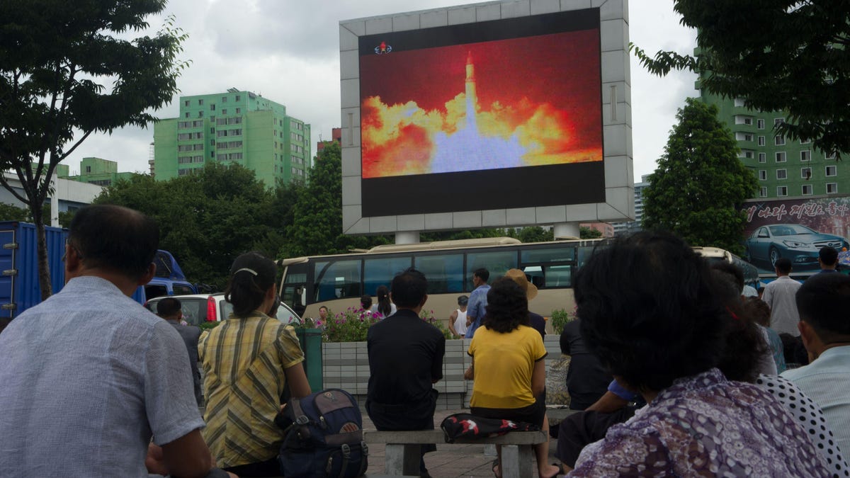 Missile launch shown on a large TV screen in a public square in Pyongyang, North Korea.