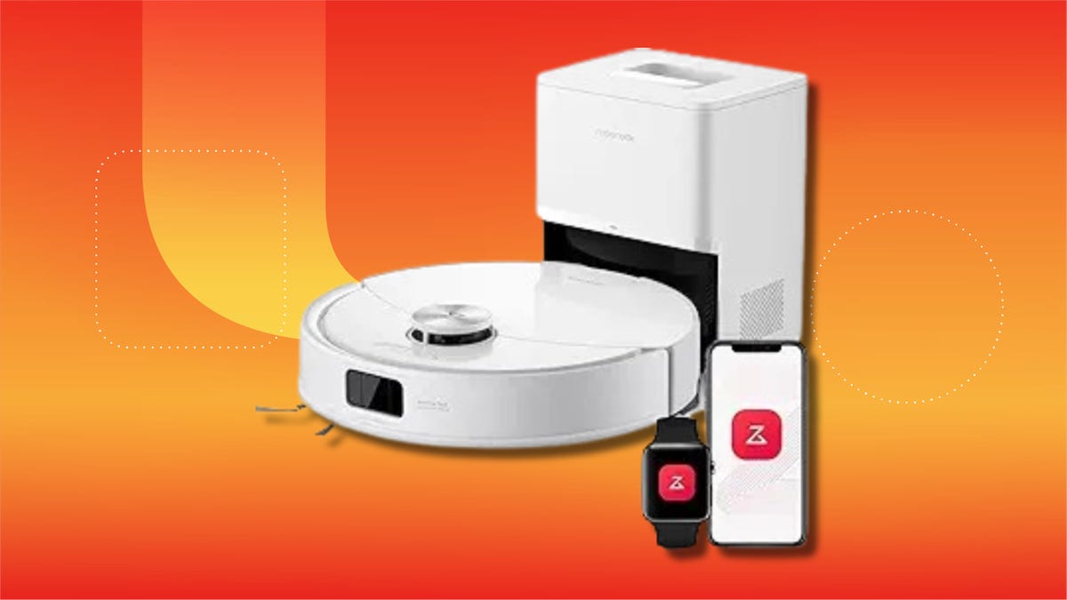 A white robot vacuum and base station against a orange gradient CNET background.