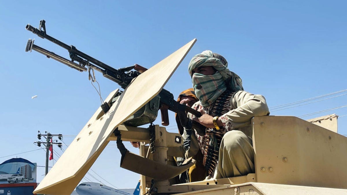 Taliban fighter with a vehicle-mounted machine gun