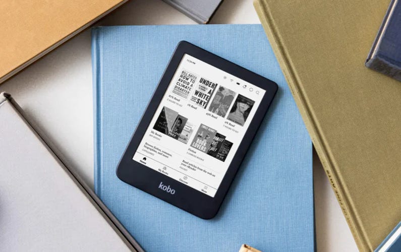 The Kobo Clara 2E sitting on top of a light blue book
