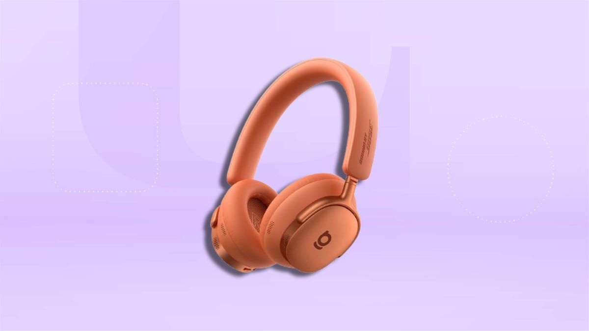 Orange Baseus headphones on a light purple background.