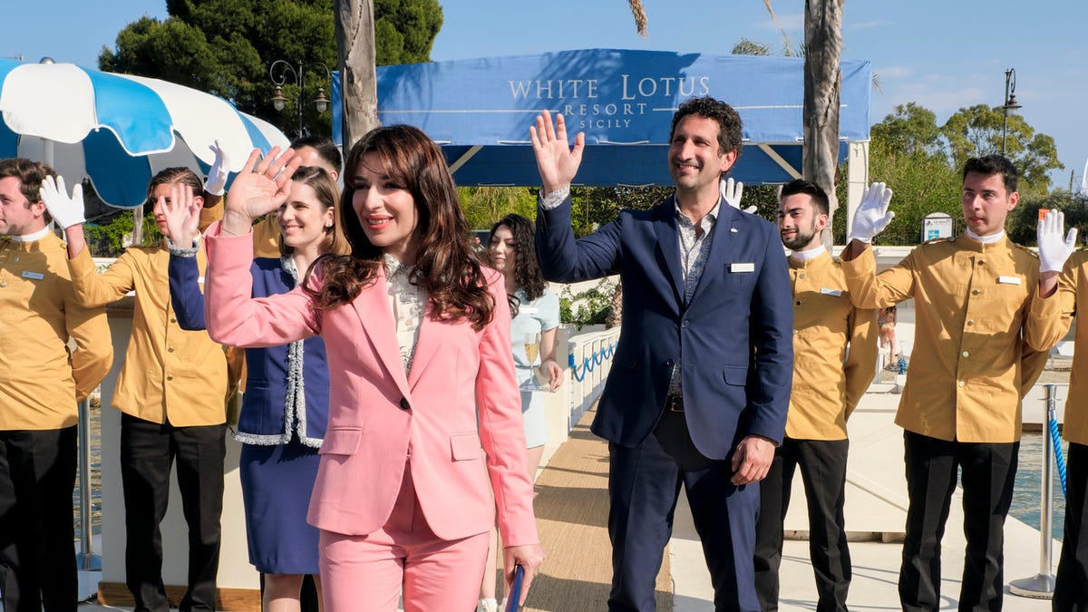 White Lotus staff members wave at guests in season 2