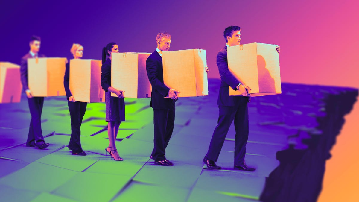 laid off workers carrying boxes in a line