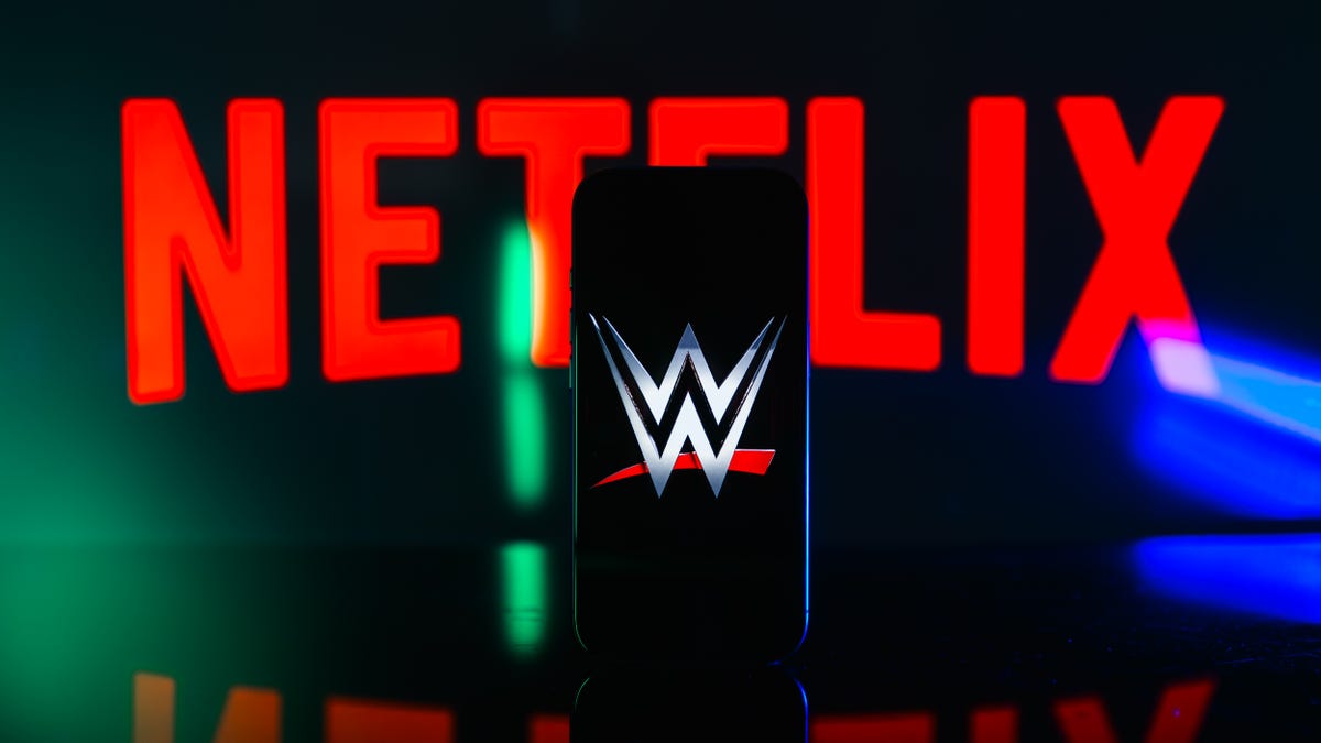 WWE logo on phone screen with Netflix logo in background