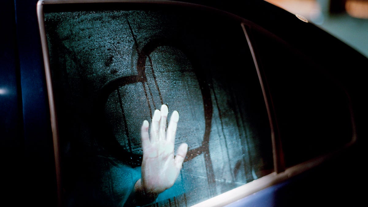 Heart drawn on fogged window of car