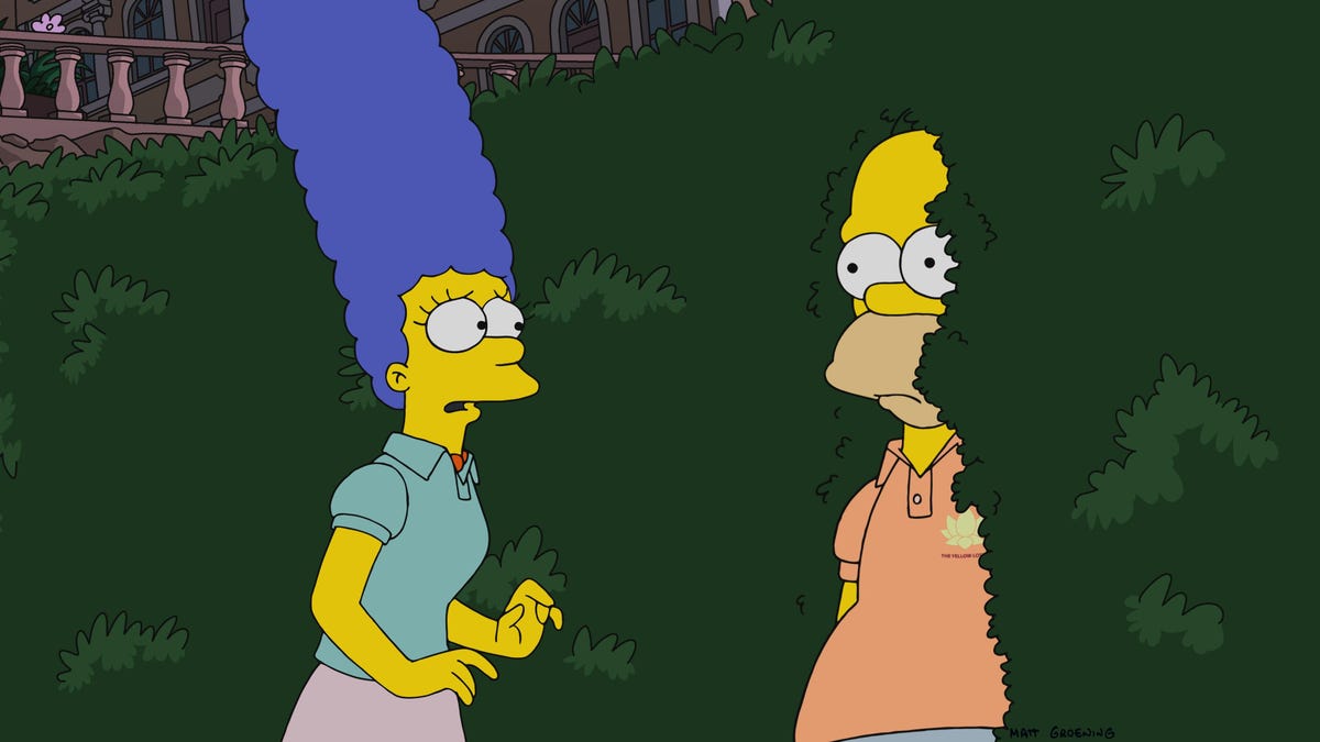 homer simpson hides in bushes while Marge looks at him