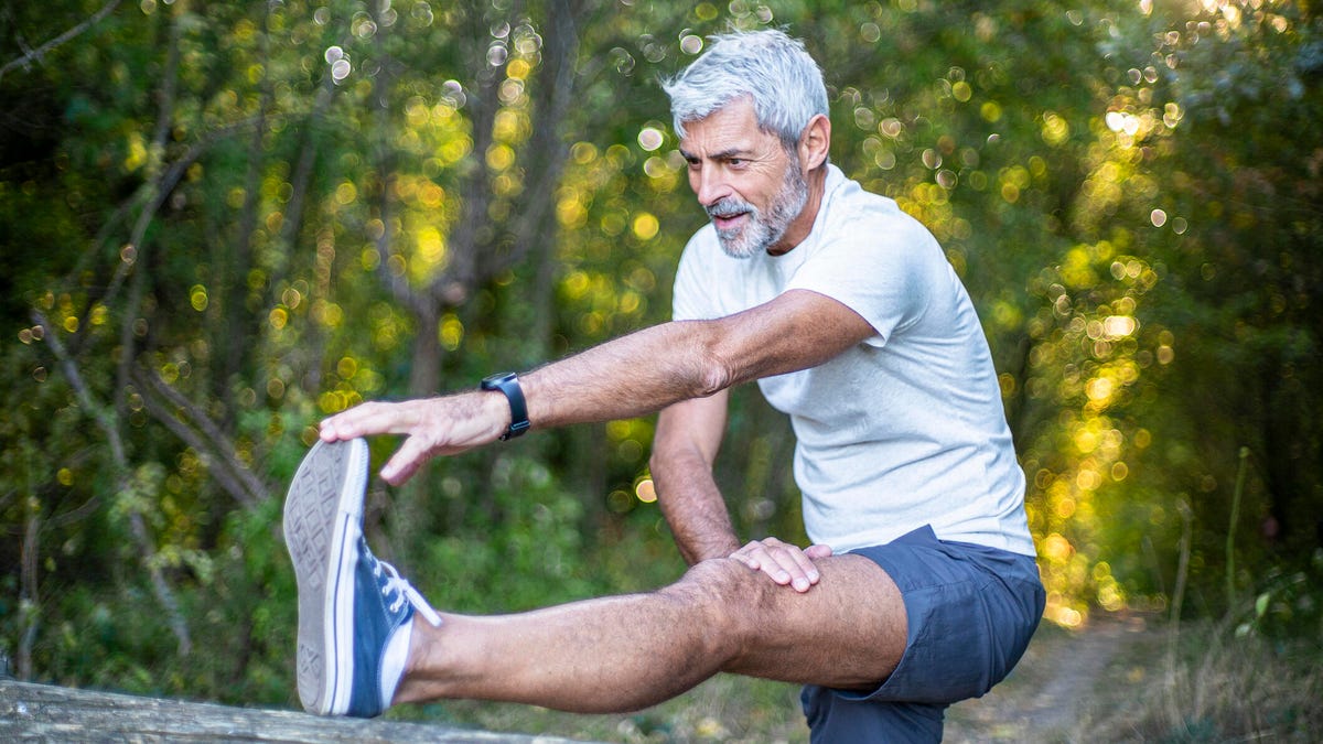 A man stretching his calf outdoors