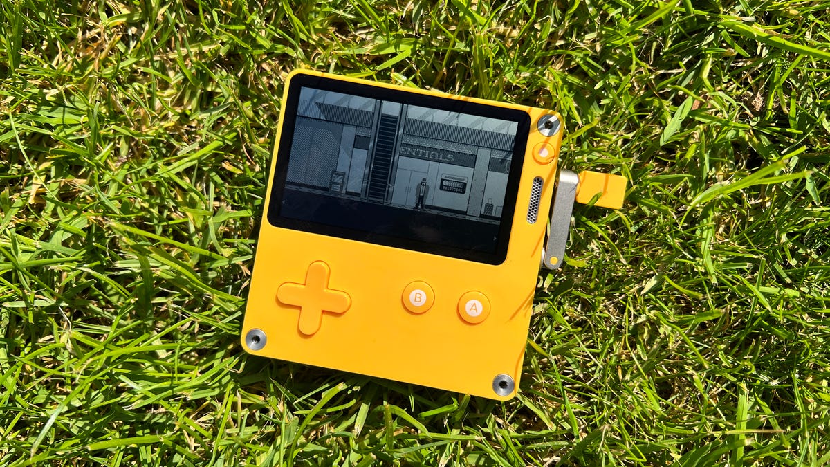 Panic Playdate hand-cranked game device lying on grass
