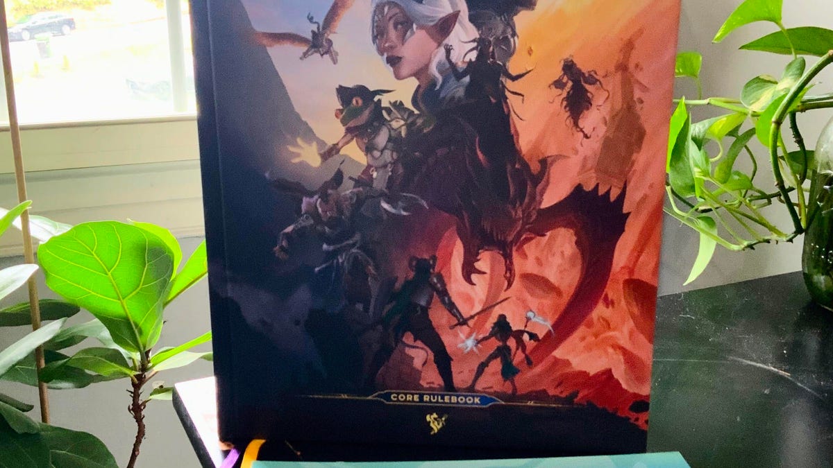 Daggerheart rulebook standing on a table in front of a window