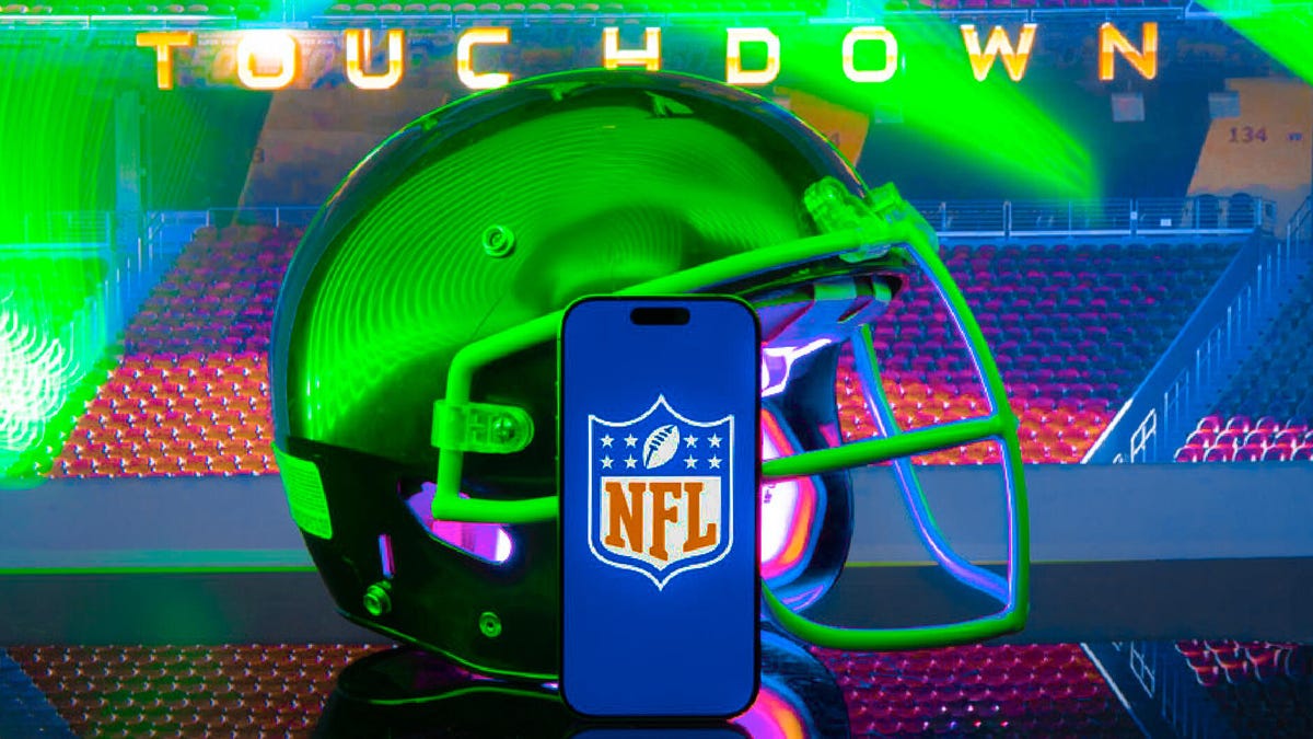 nfl logo on phone sits in front of football helmet
