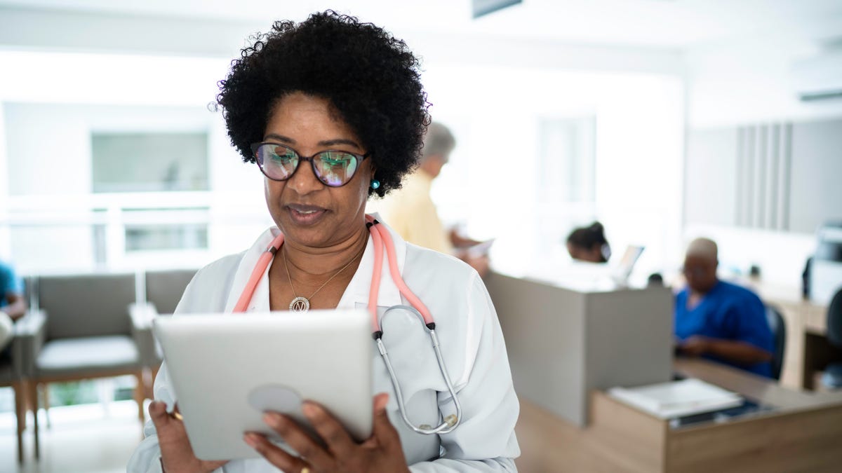 Doctor checking electronic medical records on a tablet