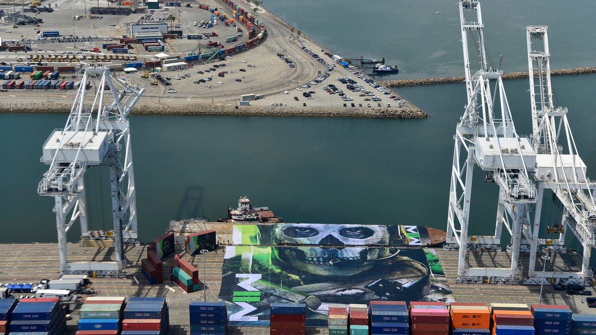 a cargo ship covered with a tarp showing the image of a character from modern warfare 2